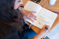 overhead shot of a woman writing in a notebook 