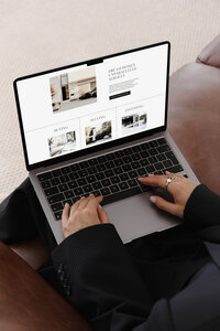 Close-up of a woman browsing a Showit website template for service-based businesses on a laptop—tailored for coaches, creatives, and modern entrepreneurs.