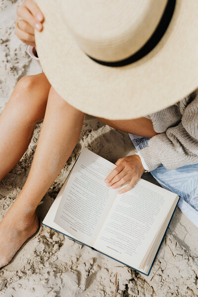 kaboompics_a-woman-reads-on-the-beach-in-the-summer-18637
