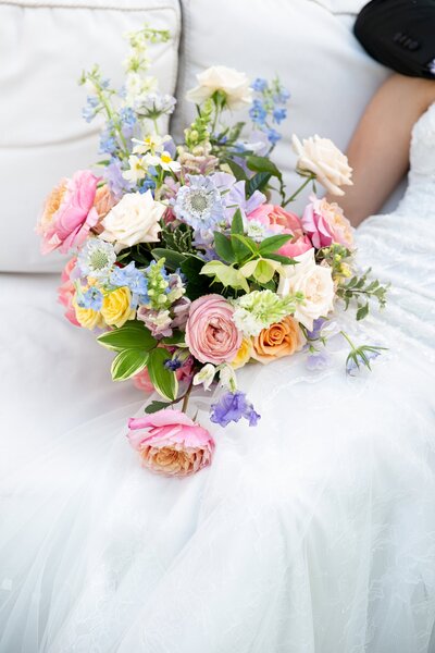 fallback shared on Invalid Date | Bridal bouquet against a white wedding dress