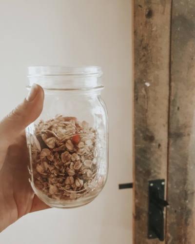 fallback shared on Invalid Date | A glass jar with homemade granola in front of a farmhouse door