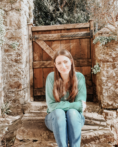 fallback shared on Invalid Date | A happy mother sits on her garden steps in front of her garden gate