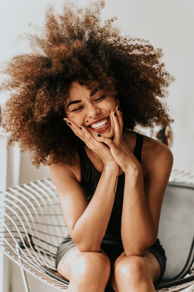 woman-sitting-and-smiling-1858175