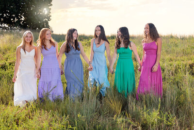 fallback shared on Invalid Date | Raleigh Teen Team laughing in a field of grass at sunset