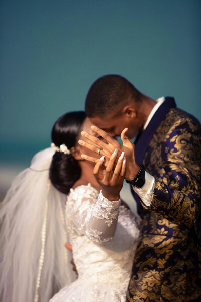 bride-groom-wedding-attire-rings-intimate-moment