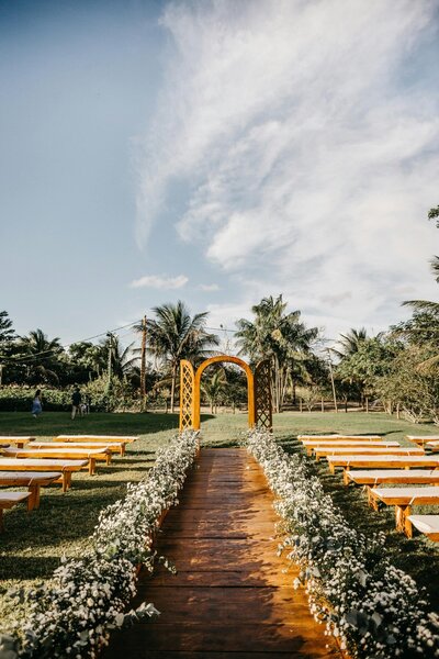 outdoor-wedding-setup-wooden-arch-floral-decorations