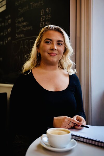 Aoibh Johnson smiling with a cofee