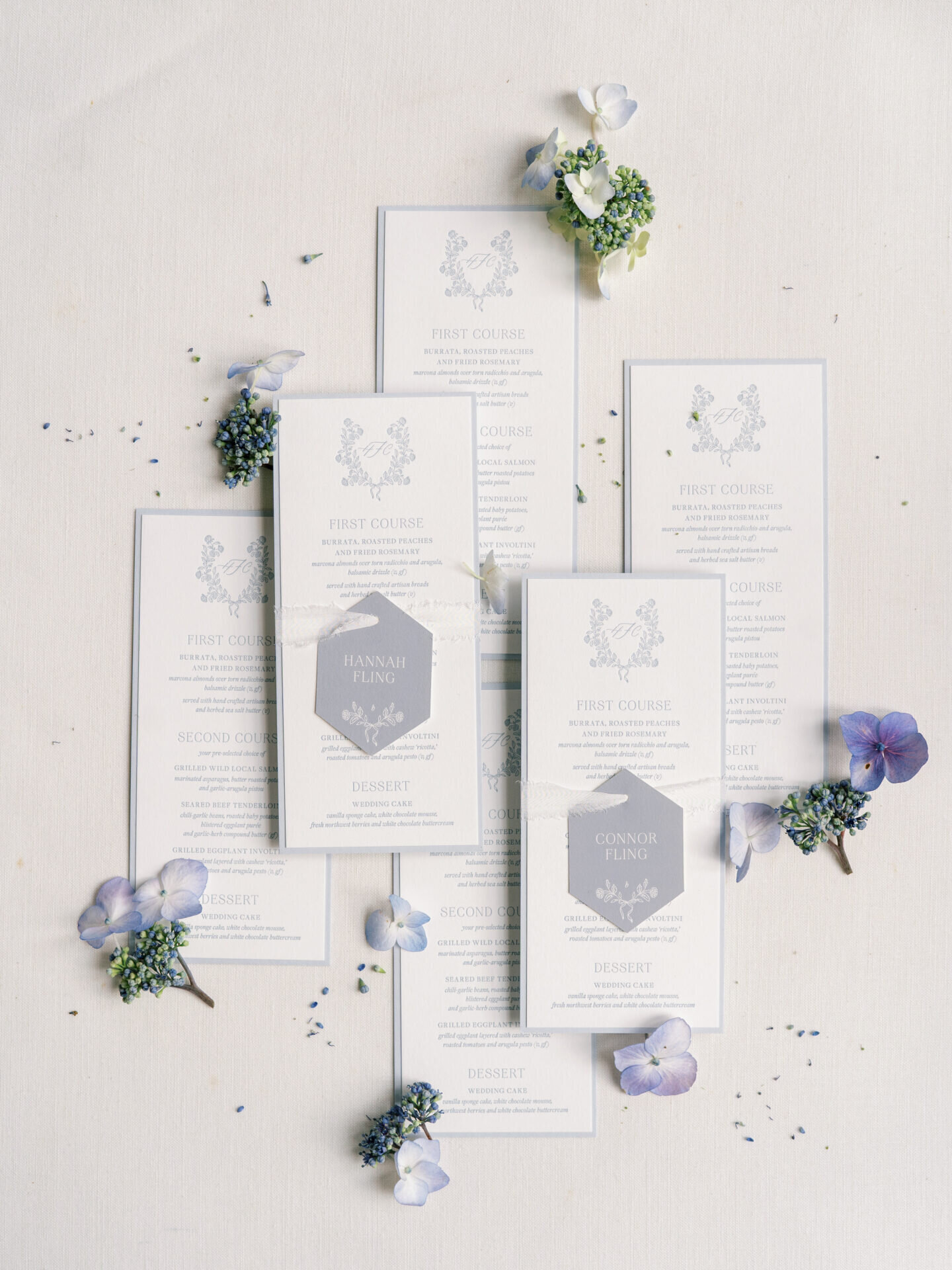wedding menus styled in a beautiufl flat lay with purple flowers