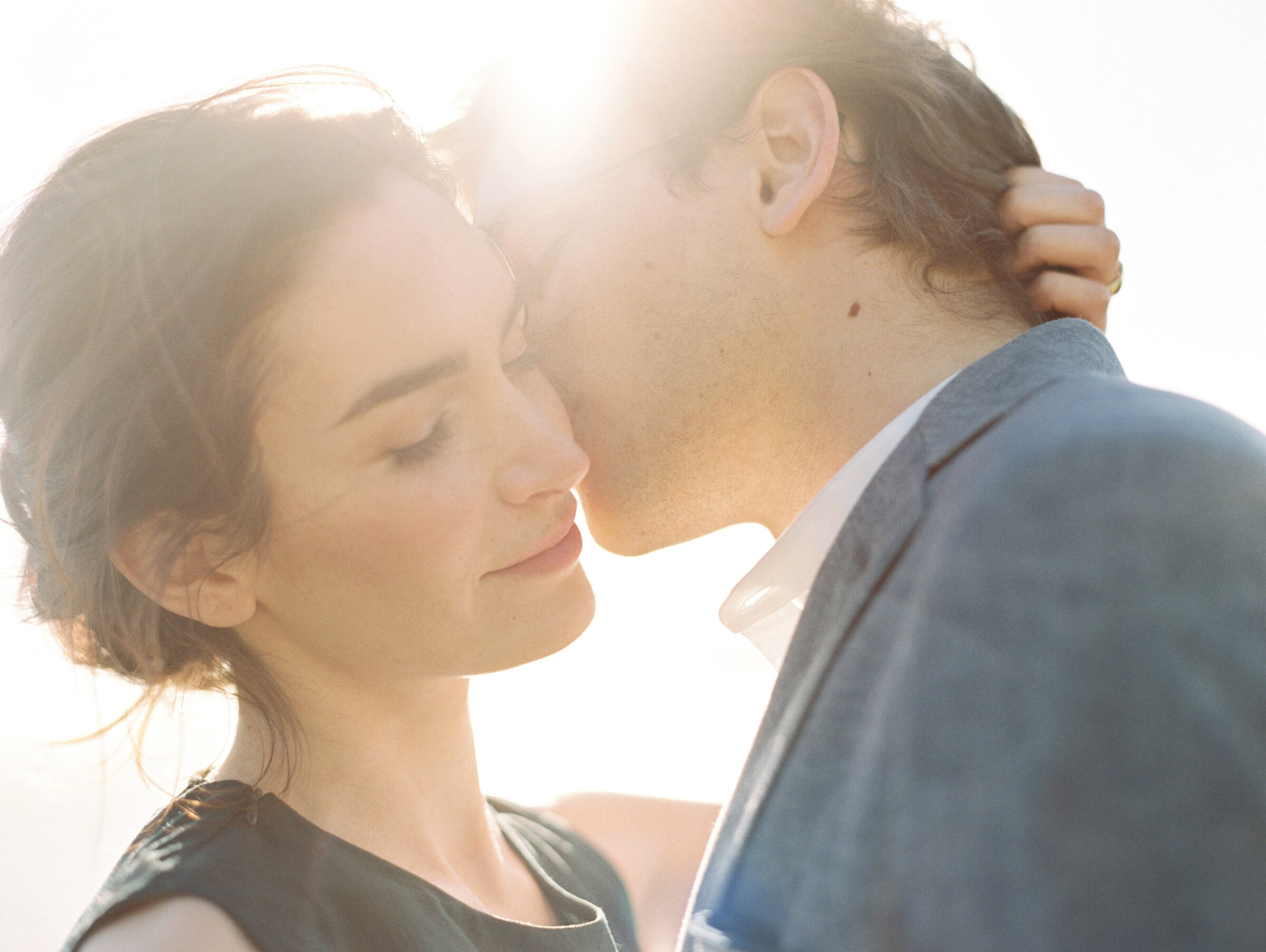 engaged couple kissing at sunset captured by a miami wedding photographer