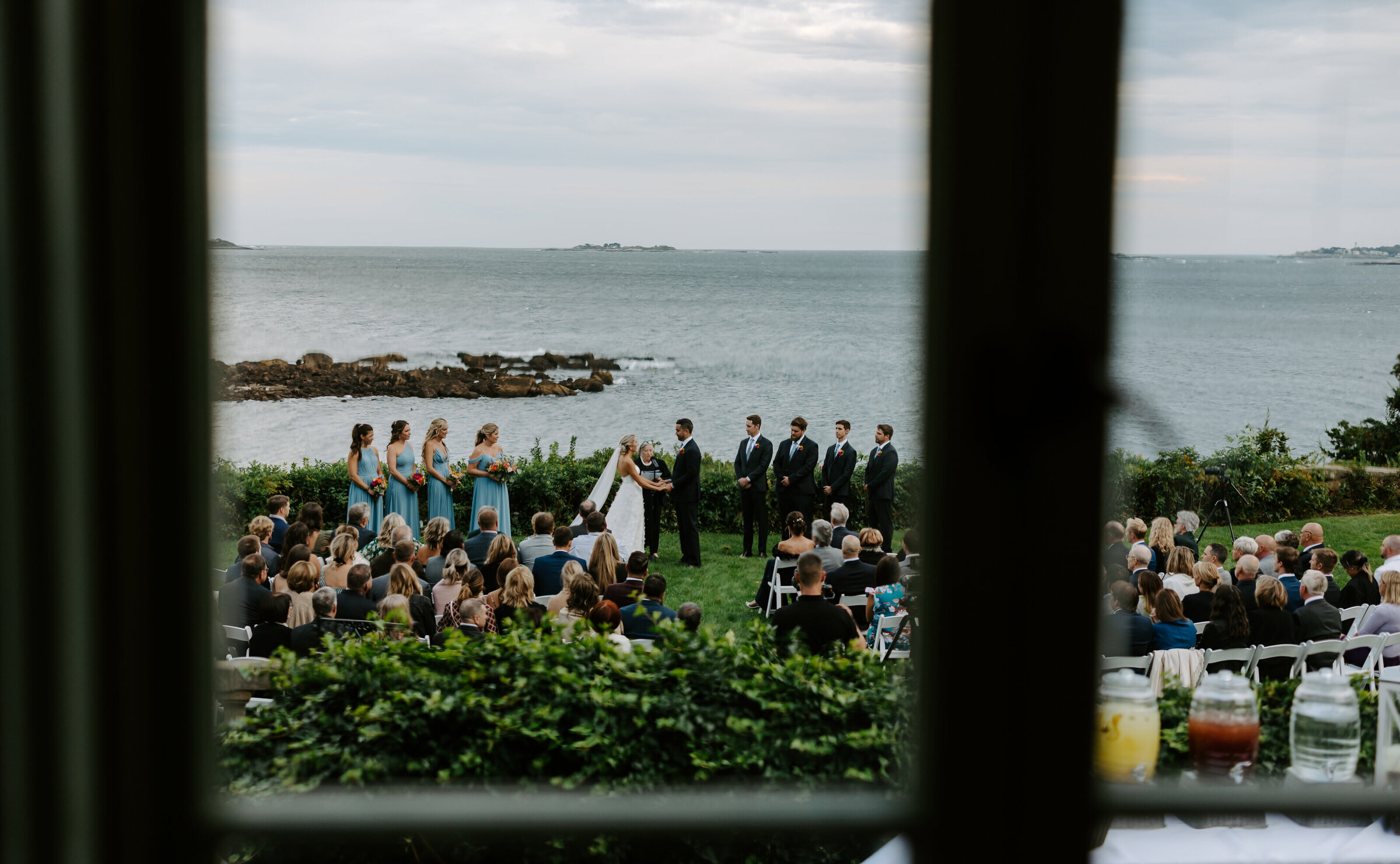 Gorgeous summer ceremony by the water at Misslewood Events at Endicot College in Beverly, Massachusetts