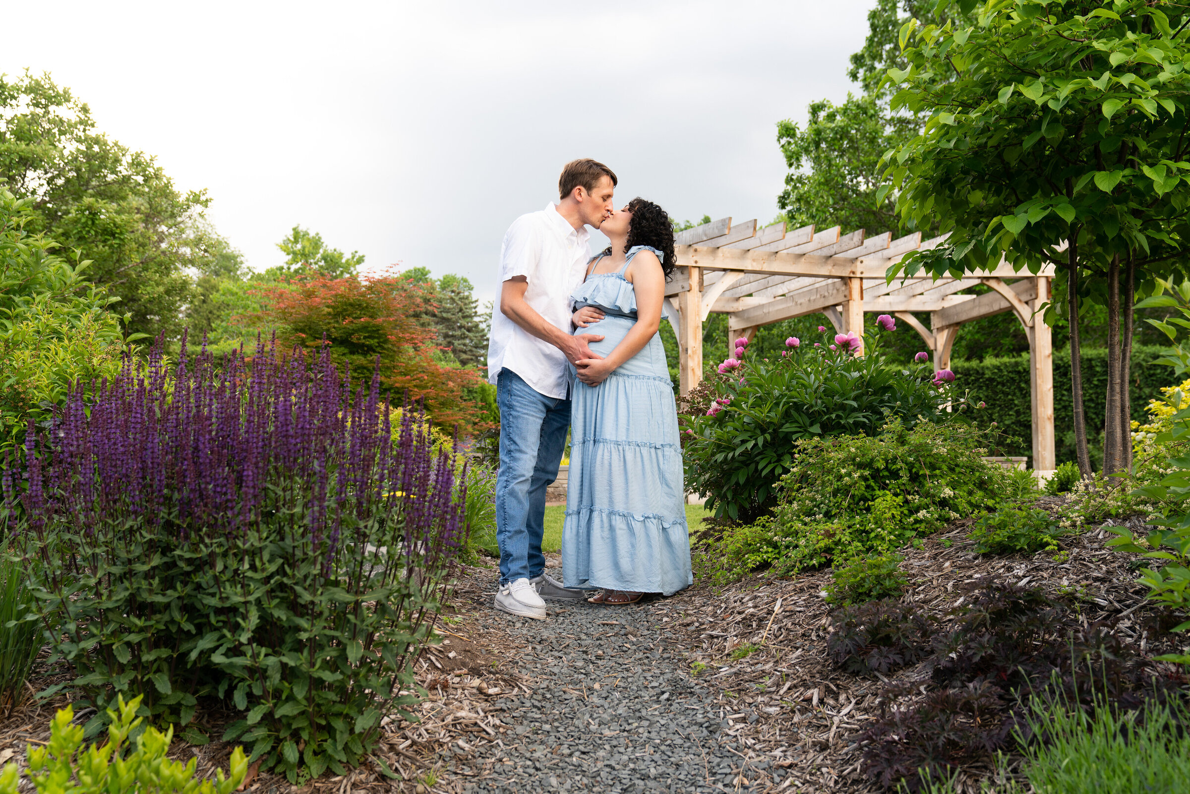 Couple kissing during their maternity session at Arneson Acres Park in Edina, Minnesota
