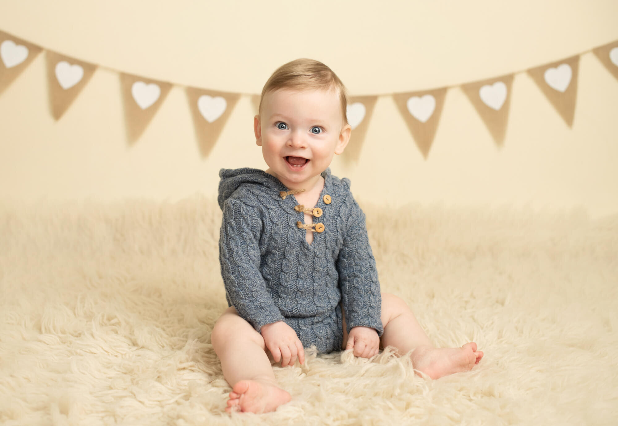 8 month old boy in blue hooded romper