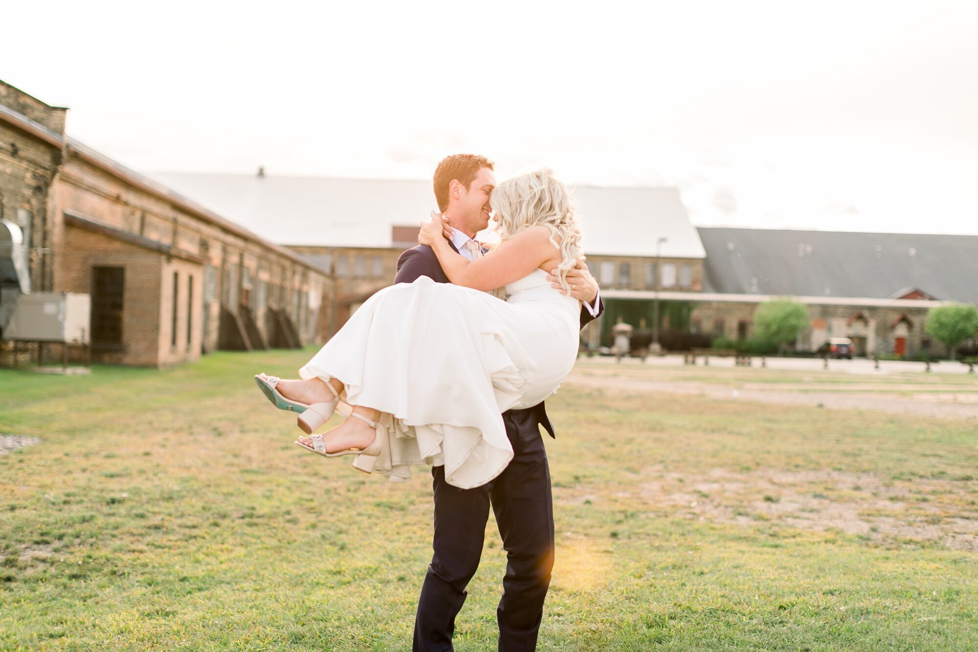 Groom carrying bride in a park, taken by wedding photographer minneapolis
