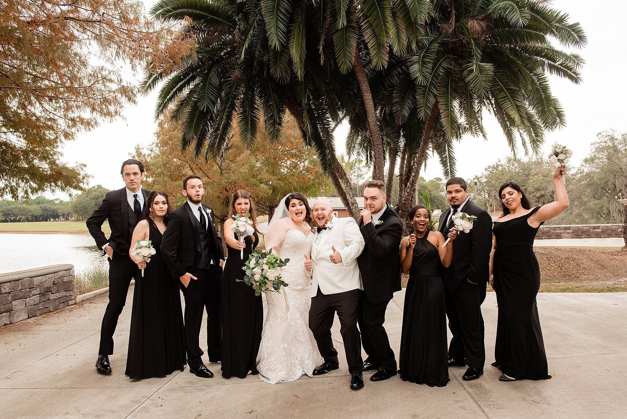 Classic black and white attire for wedding in Orlando featuring palm trees
