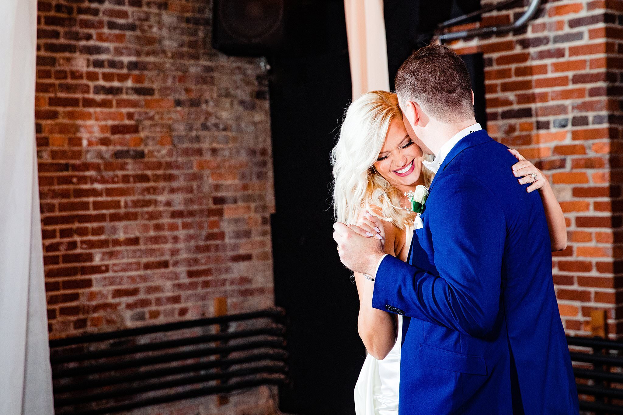 Groom whisper to his new wife while sharing a first dance together