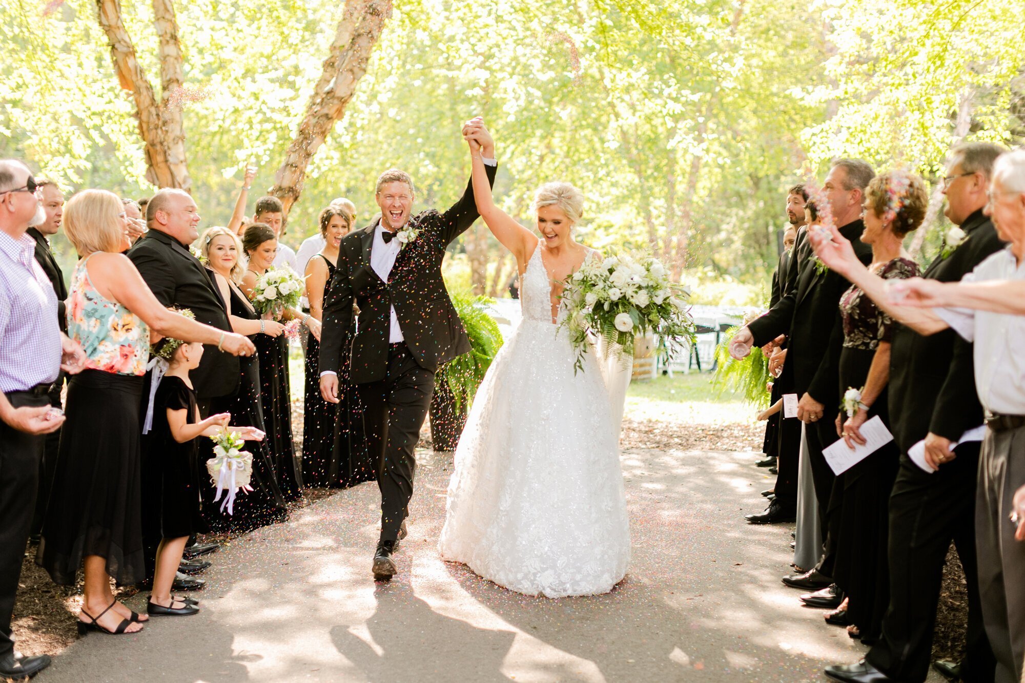 Bride and groom holding hands and walking down the aisle, taken by wedding photographers minneapolis
