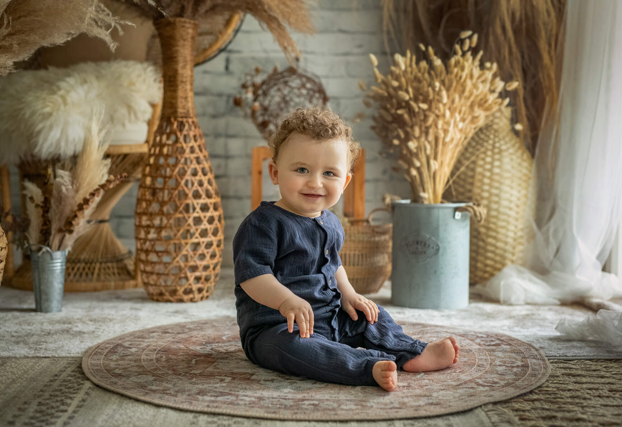 Baby boy in blue romper in window light