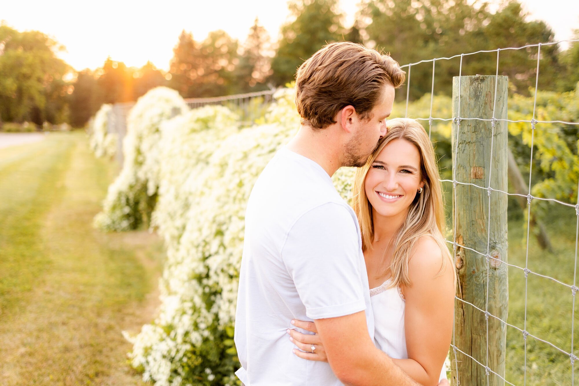 man kissing woman's temple taken by wedding photographers minneapolis Kacey Wyrick Photography