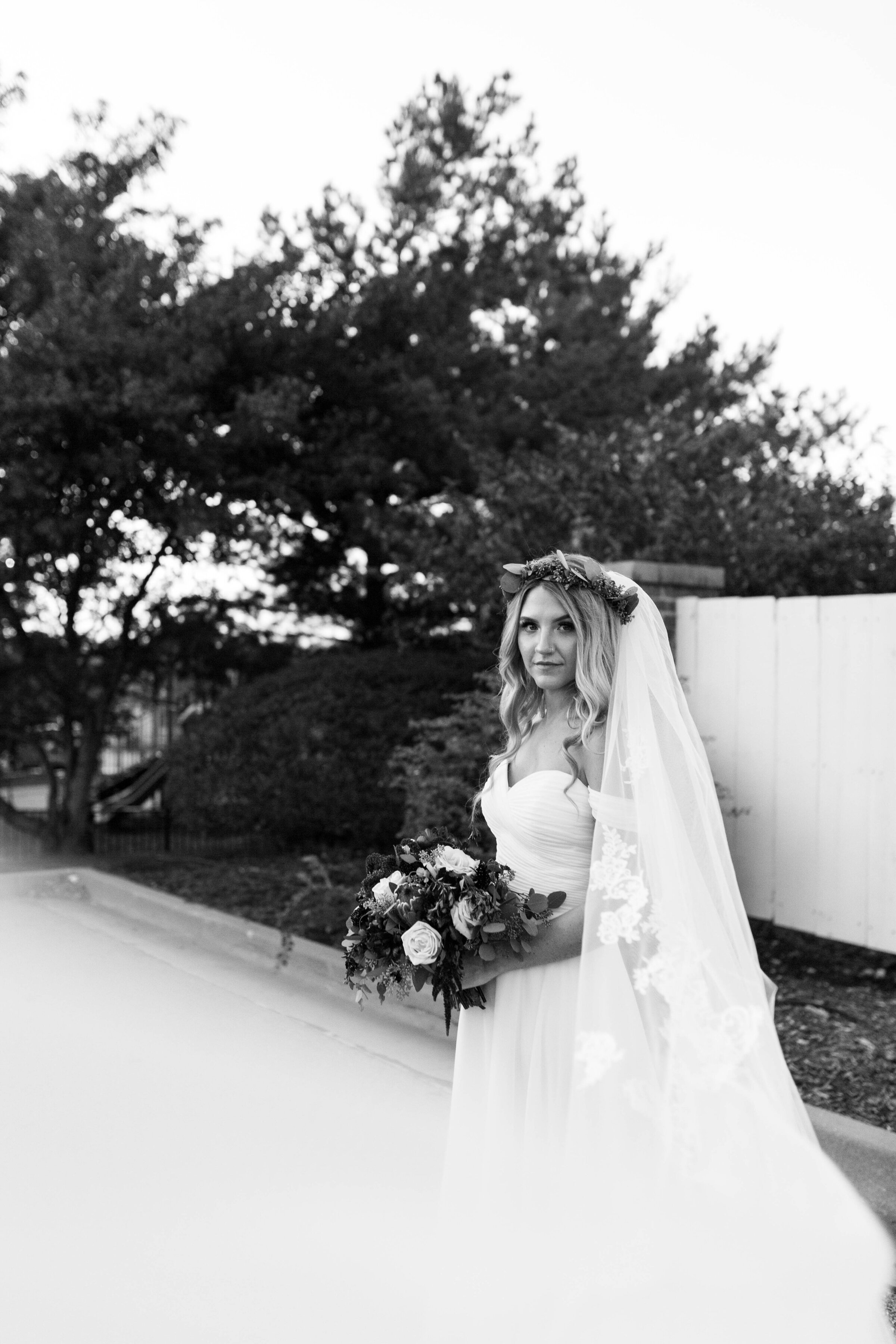 Bride carrying flowers during bridal portraits. 