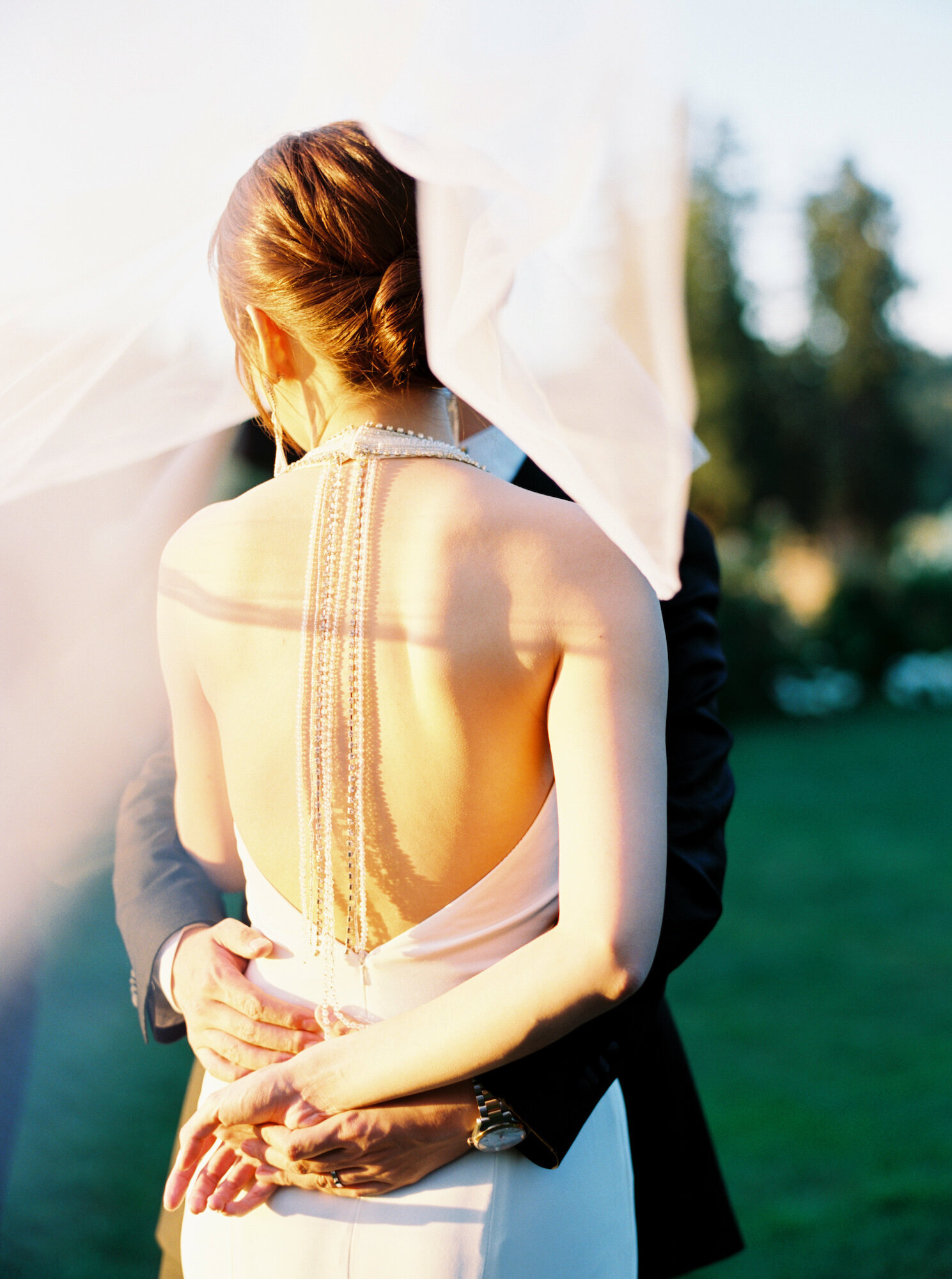 the back of the bride with rhinestones dangling from neckline down her back