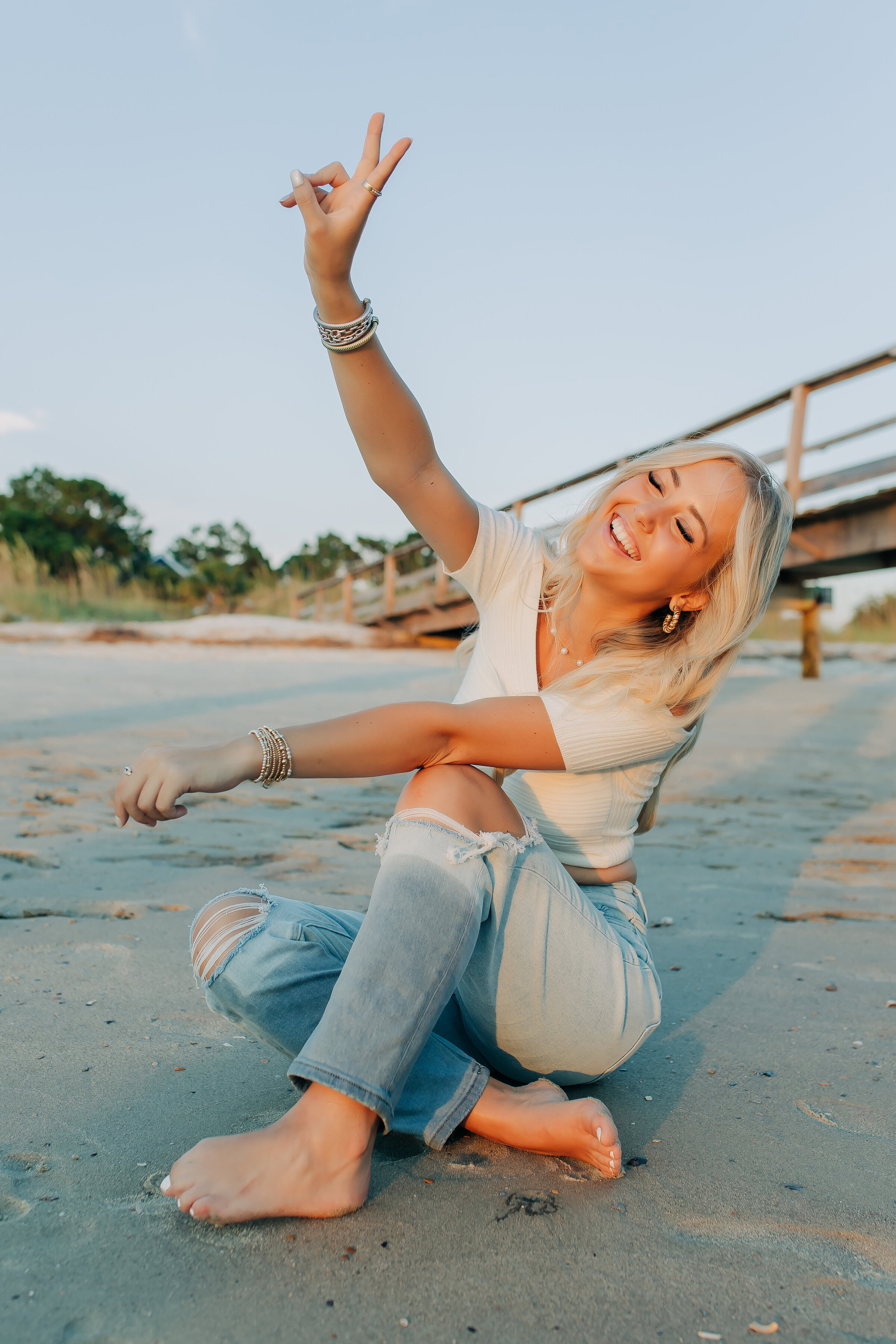 Teen standing on a dock overlooking at the ocean..