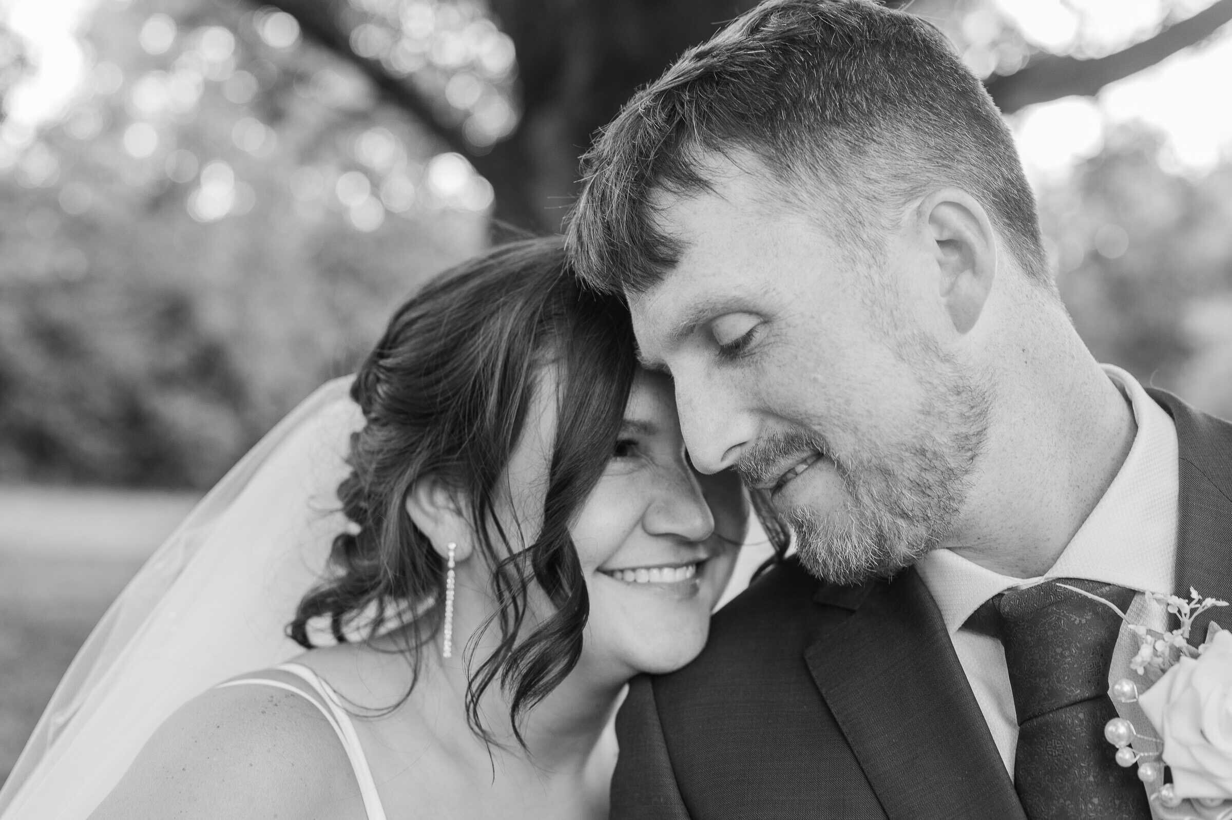 Bride and Groom rest their foreheads together sharing a sweet smile