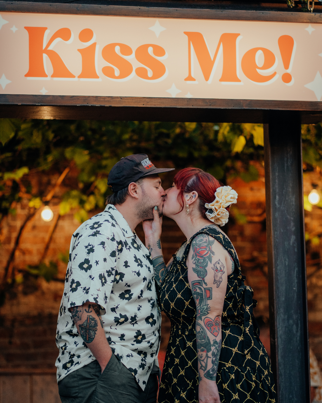 I&F Kissing under sign