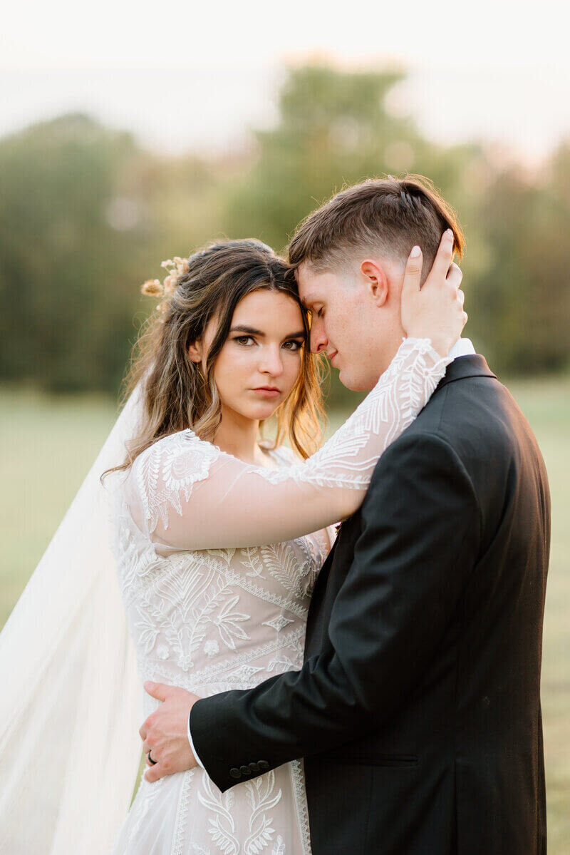 groom nuzzling up to bride by lexington wedding photographer