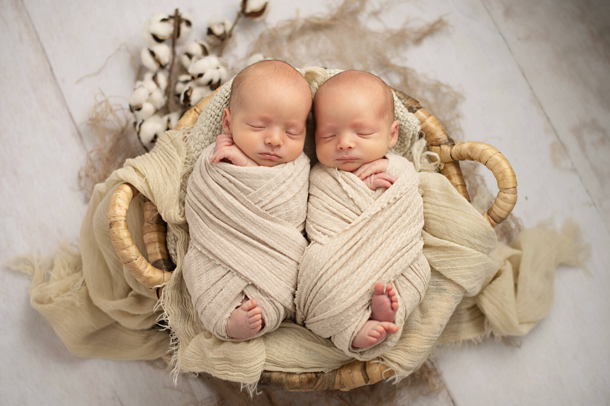 twin babies in cream wraps with cotton details