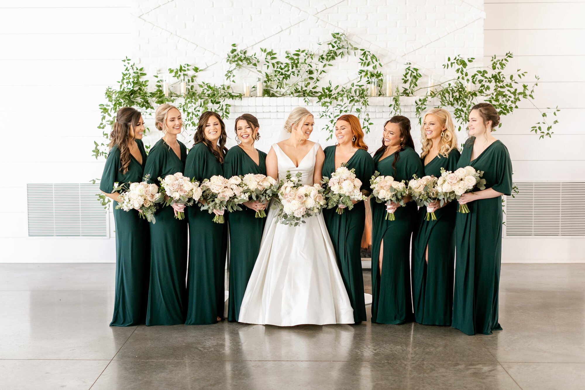 bride with bridesmaids holding flowers taken by minneapolis wedding photographer