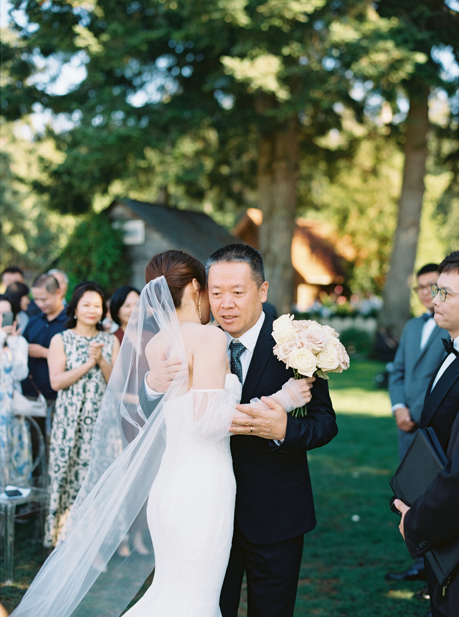 bride hugging father at ceremony