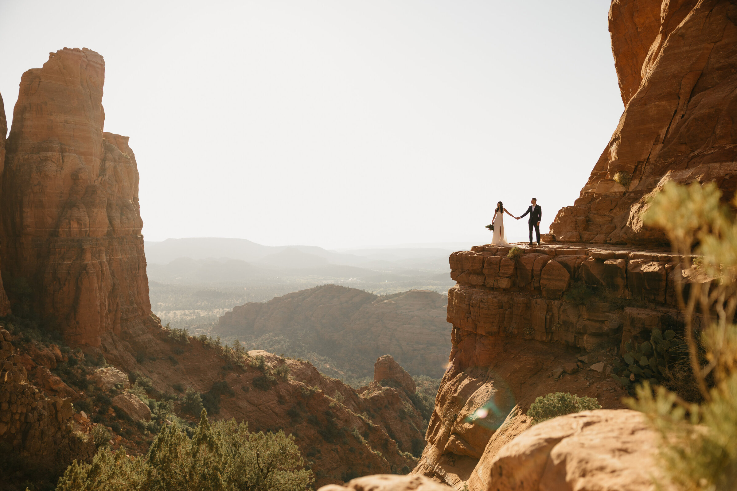 bride and groom on a cliff