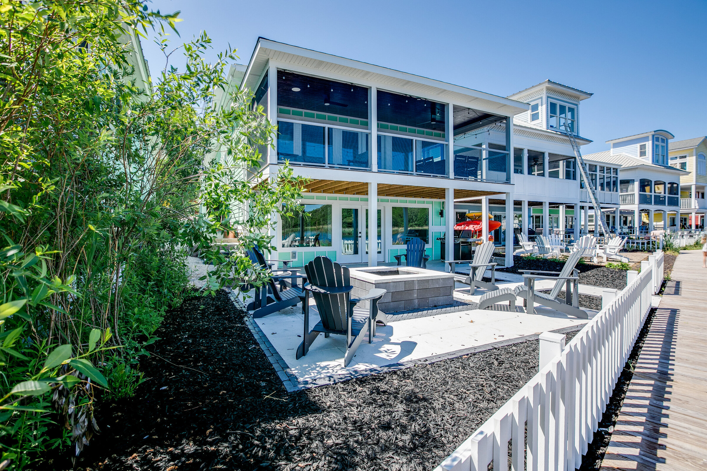 A picturesque backyard shot showcasing a home with double balconies and sleek glass railings. The modern design elements provide a seamless connection between indoor and outdoor spaces, enhancing the home's luxury appeal.