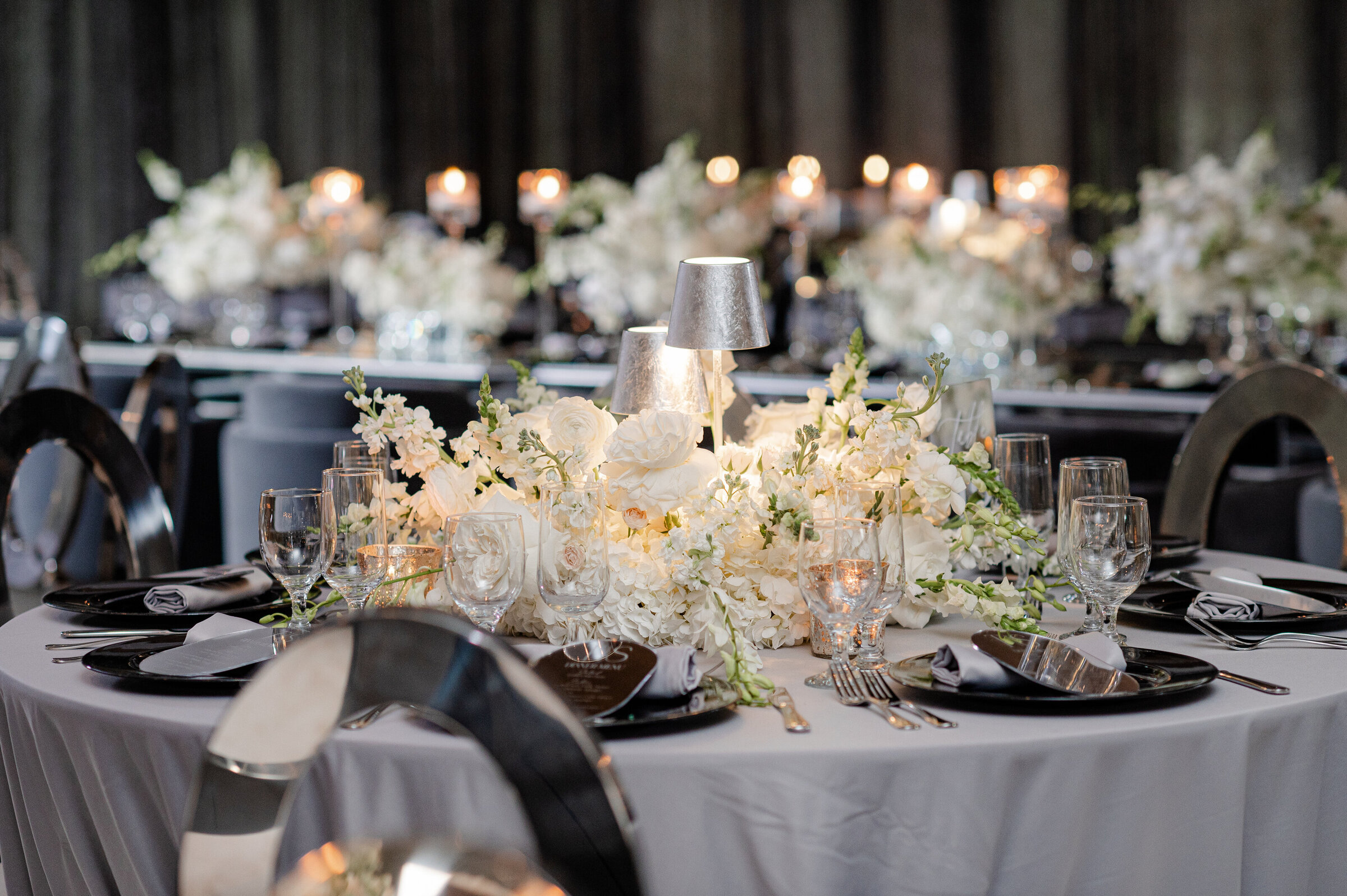 Elegant gray and white wedding reception decor with luxury floral centerpieces by Wells Design Co.