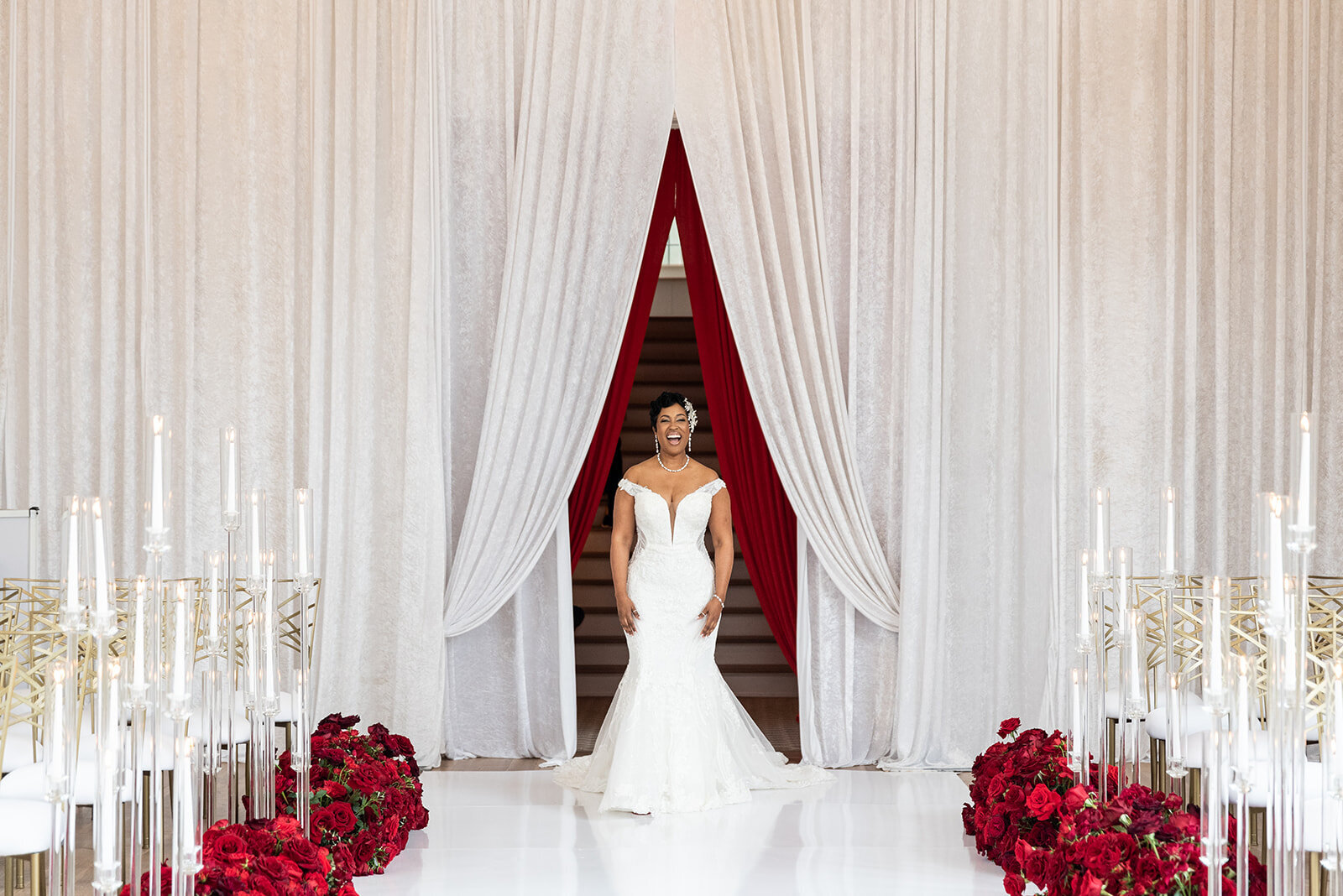Bride walking down the aisle surrounded by elegant décor and floral artistry