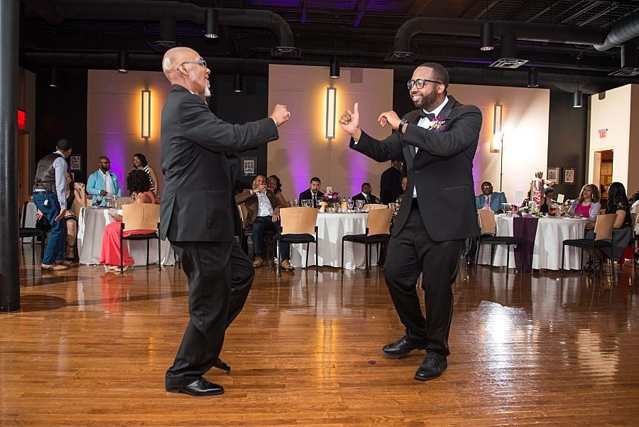 Groom dances with his dad on the dance floor at W.O. Smith Music School
