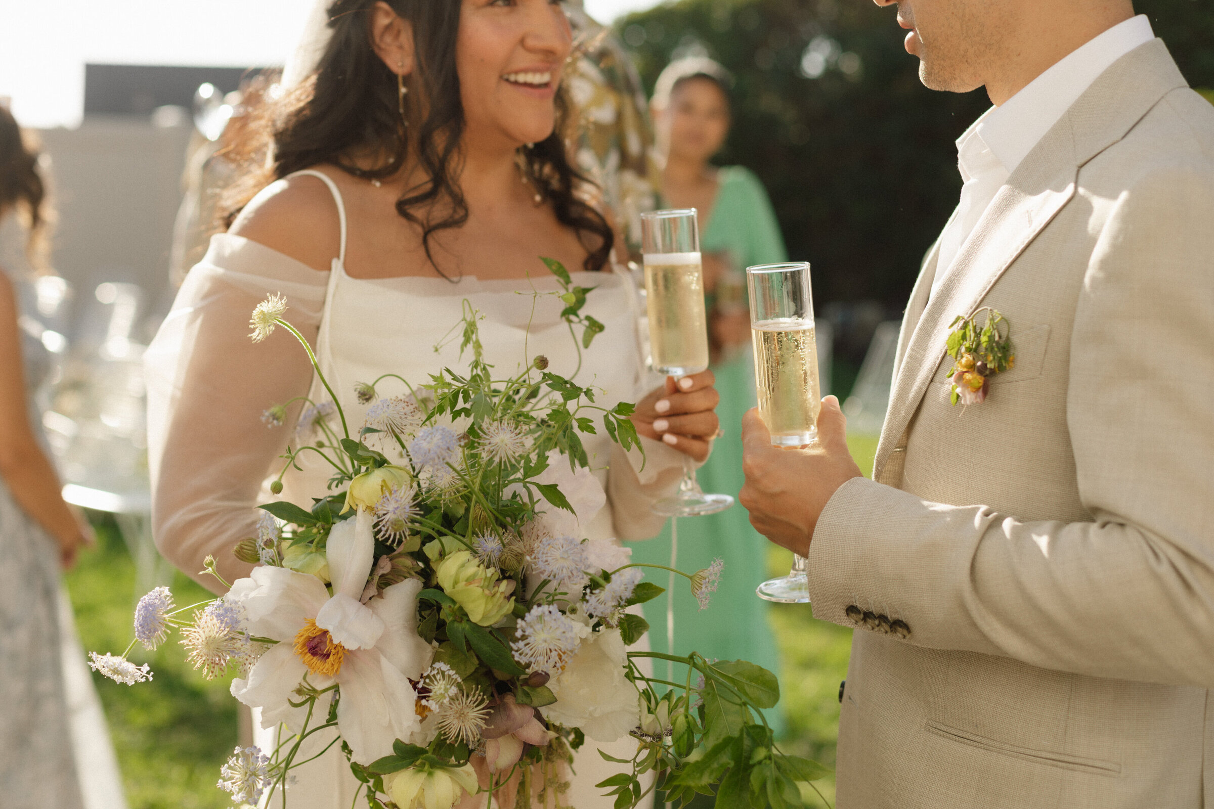 bride and groom holding champagne glasses