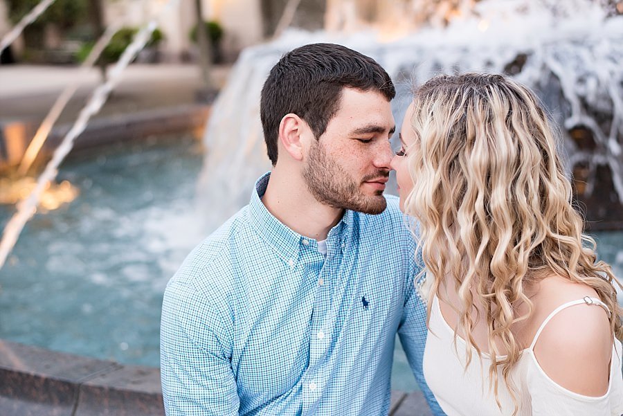Close up photo of couple about to kiss while sitting on the fountain ledge outside of the schermerhorn symphony center