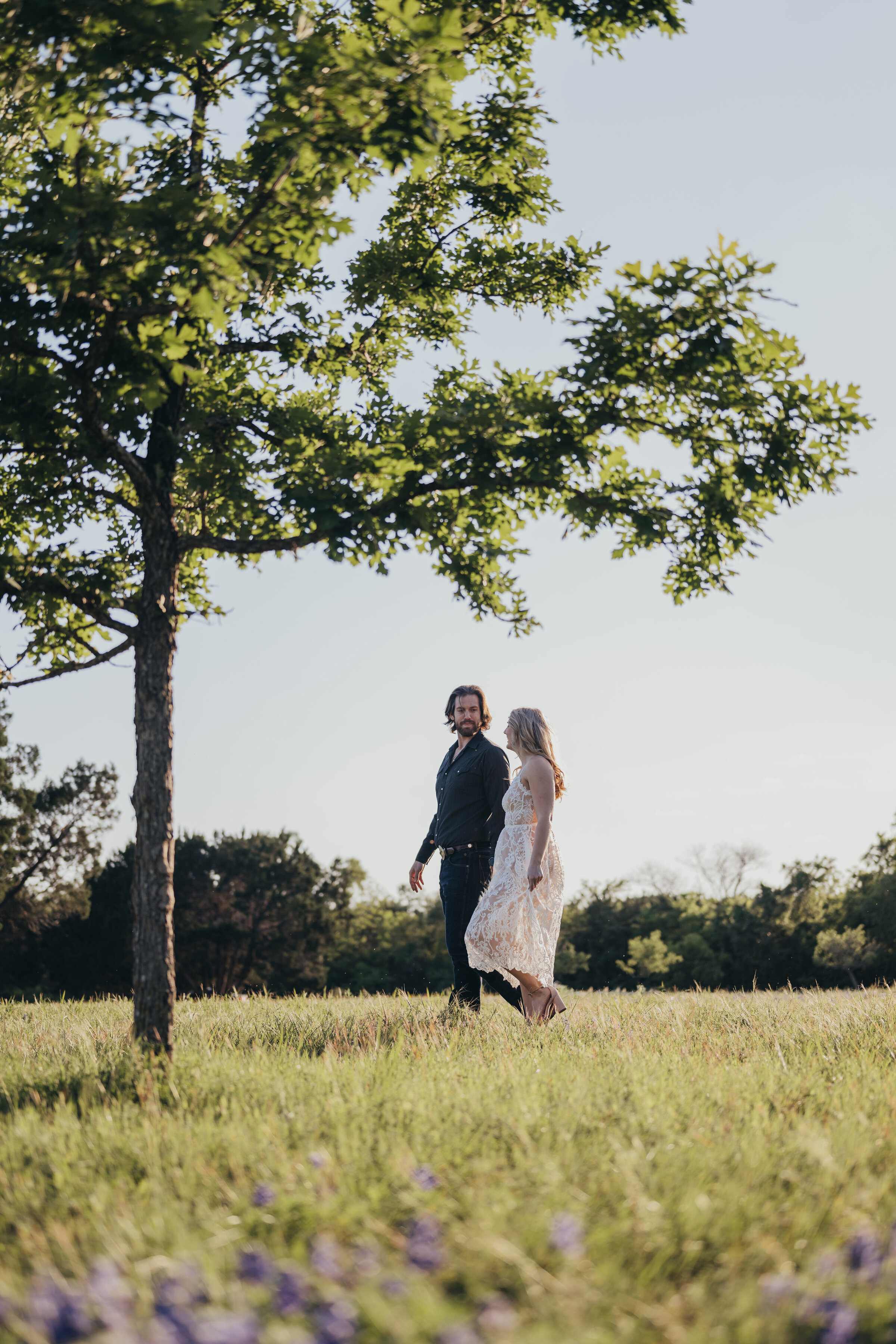 couple-session-walking-through-texas-bluebonnets