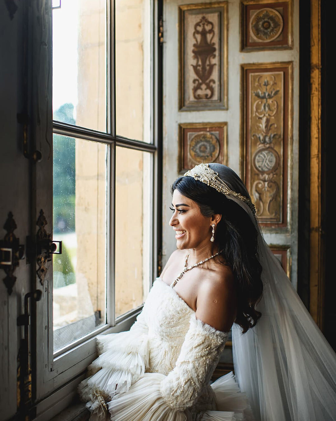 Bride wearing ornate wedding gown with large sleeves
