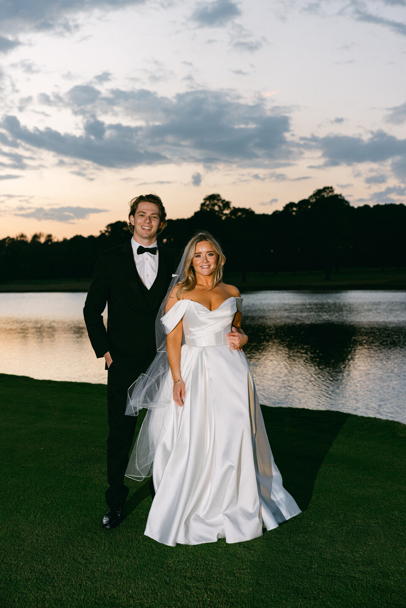 Photo of the newly wed couple smiling during in front of the lake at Texarkana Country Club