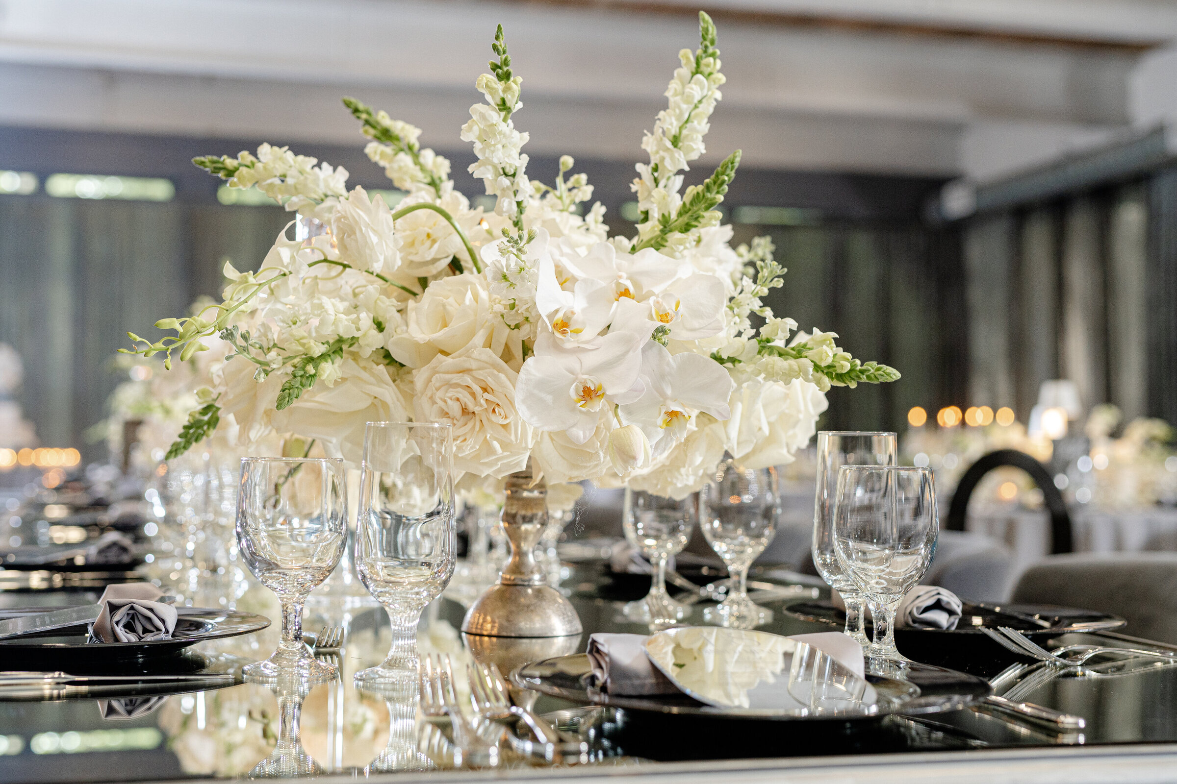 Elegant gray and white wedding reception decor with luxury floral centerpieces by Wells Design Co.