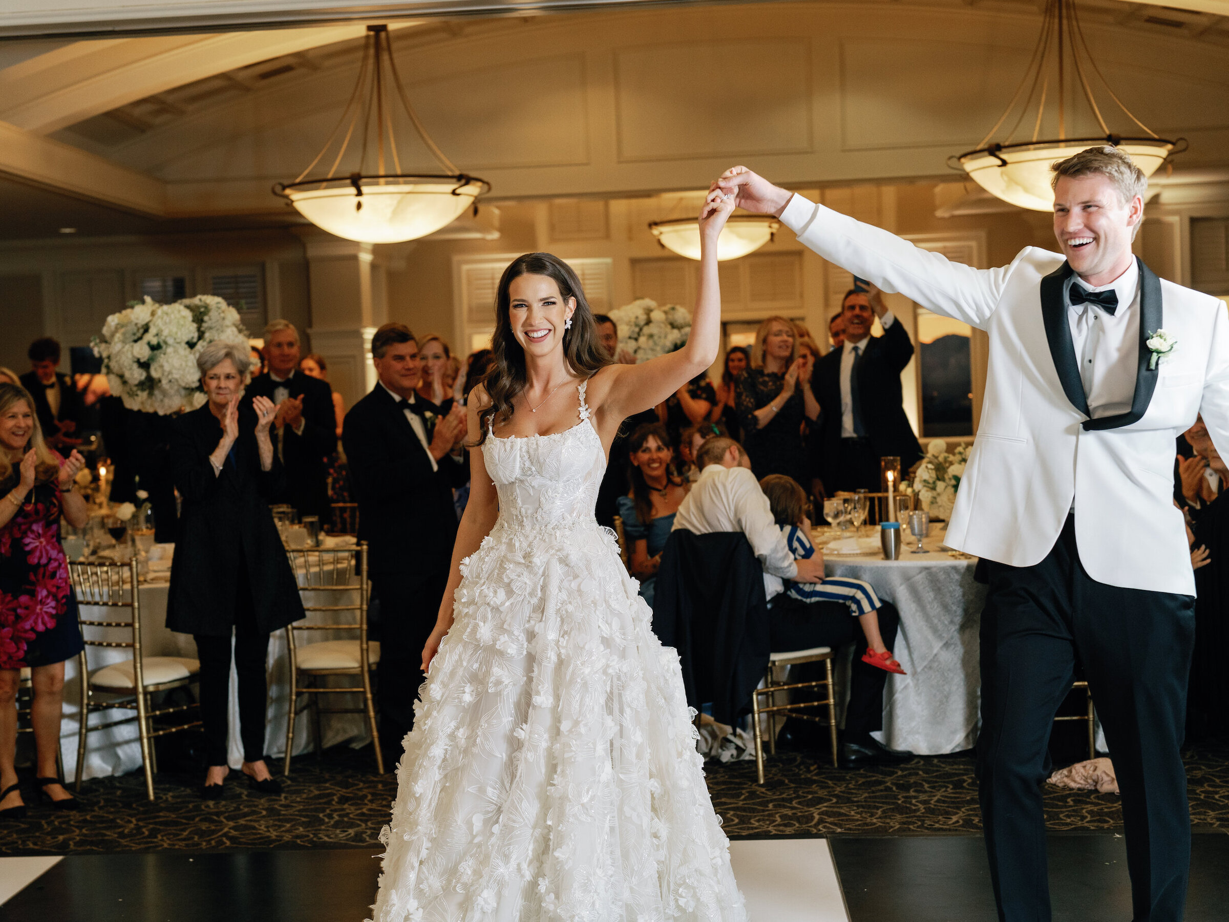 bride and groom first dance in ballroom on checkered dance floor