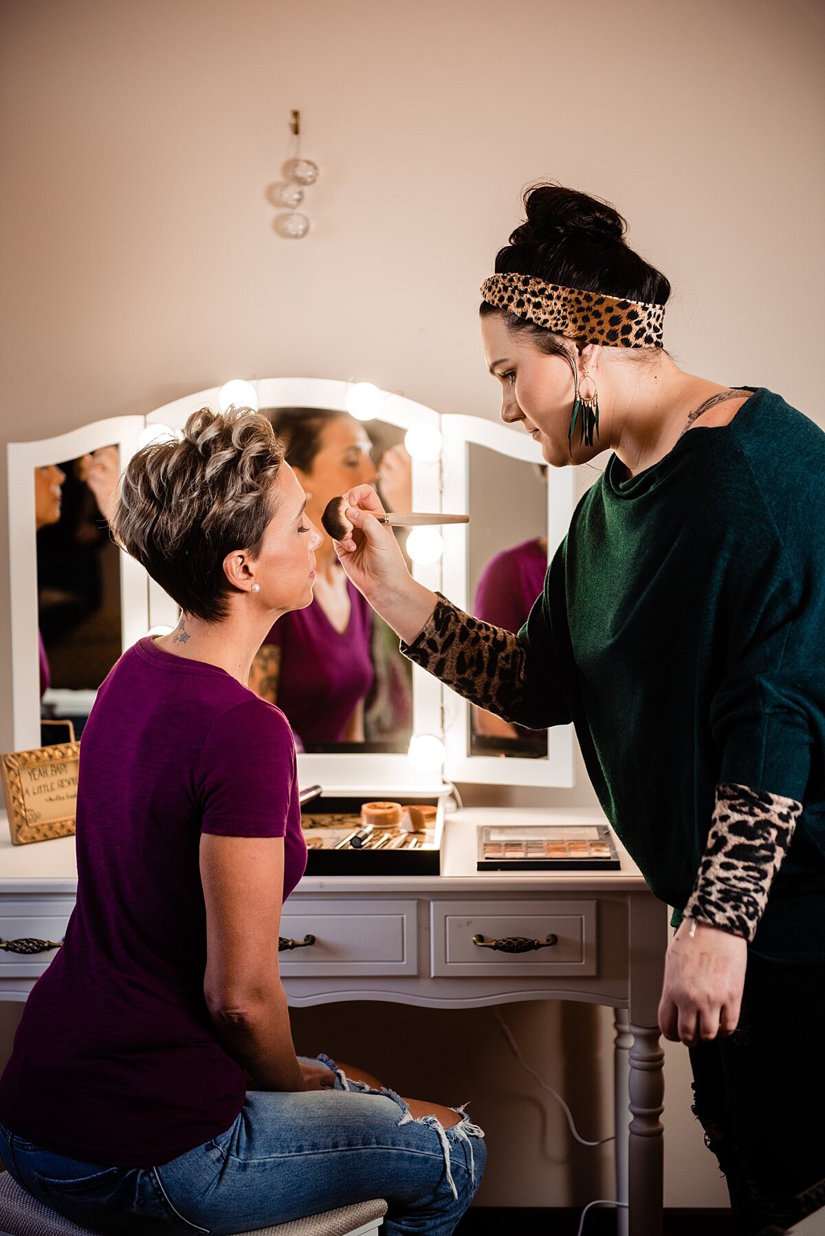 Behind the scenes photo of Molly Brown putting makeup on a bride for a styled photoshoot at The Walnut House