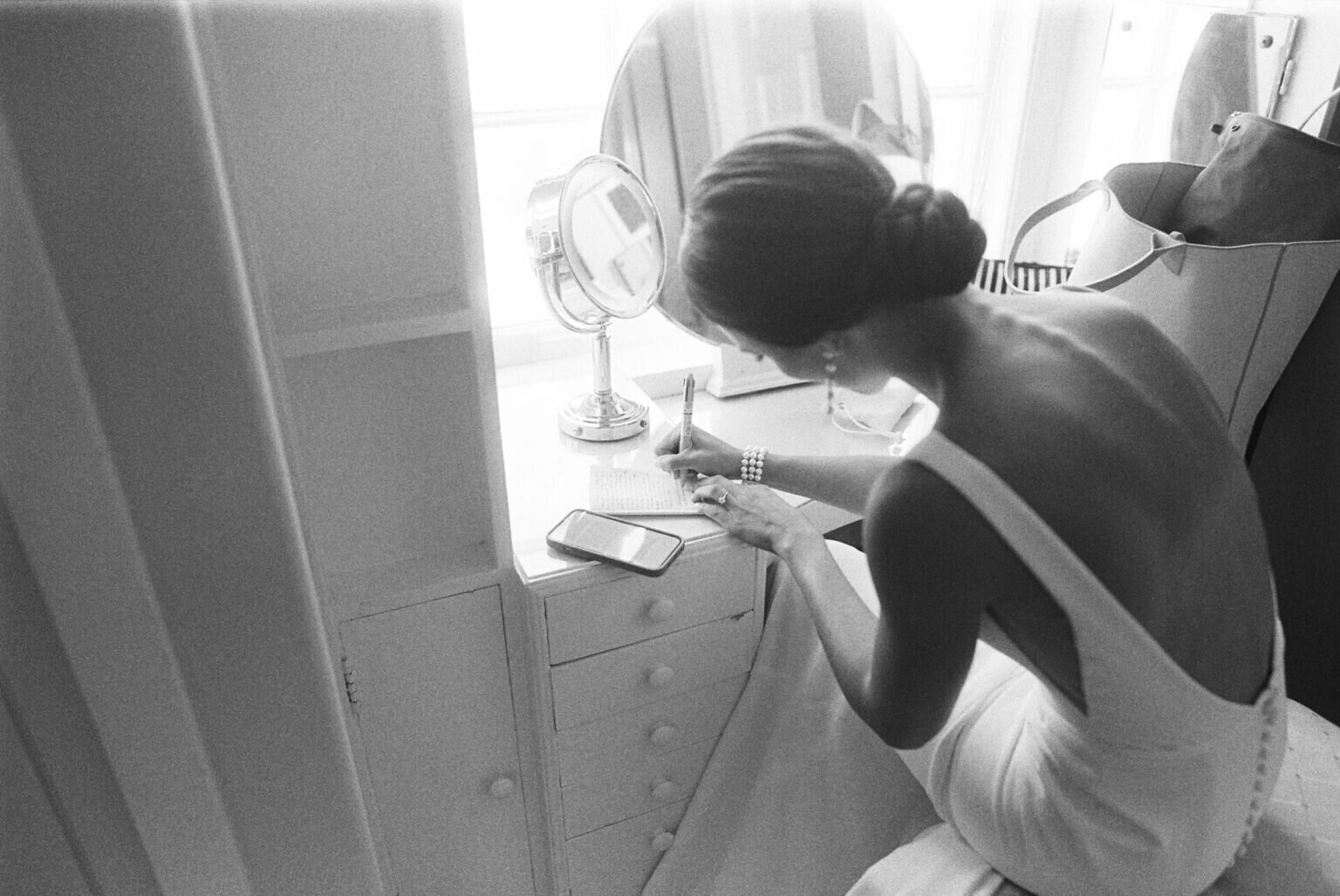 bride writing her vows in black and white image