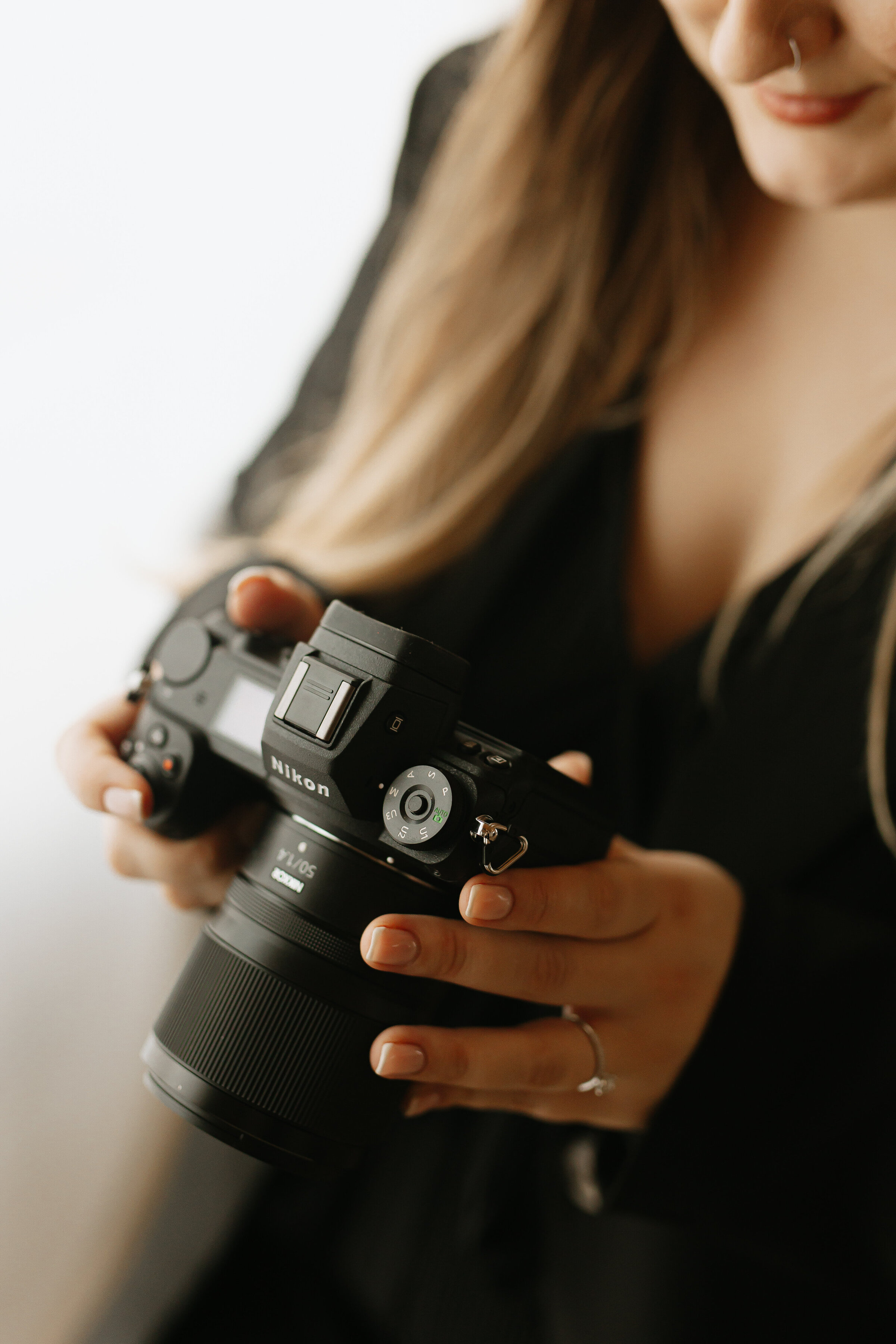 Women looking through her camera at photoshoot in Horsham