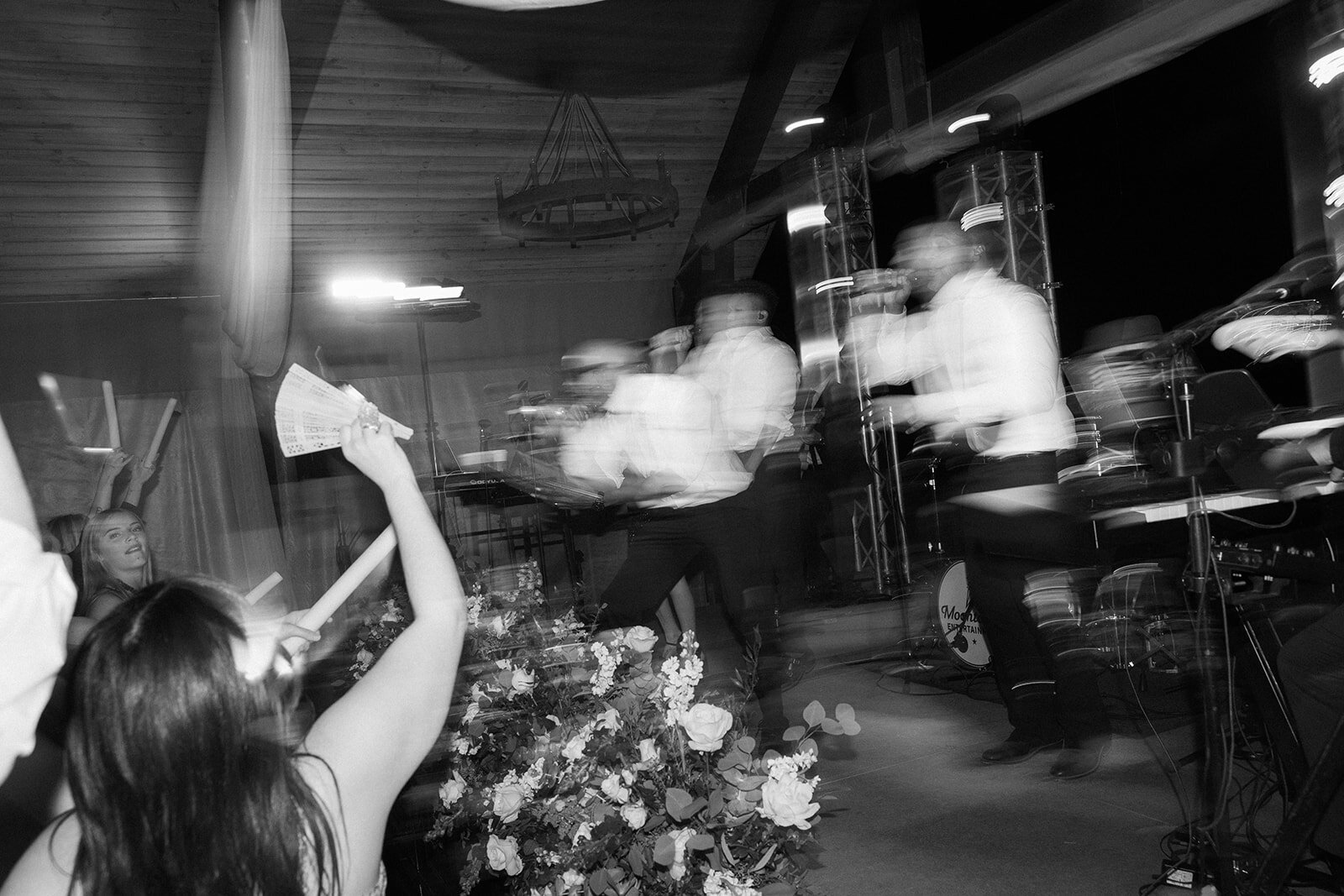 A live band at a wedding while guests are dancing to the music. 