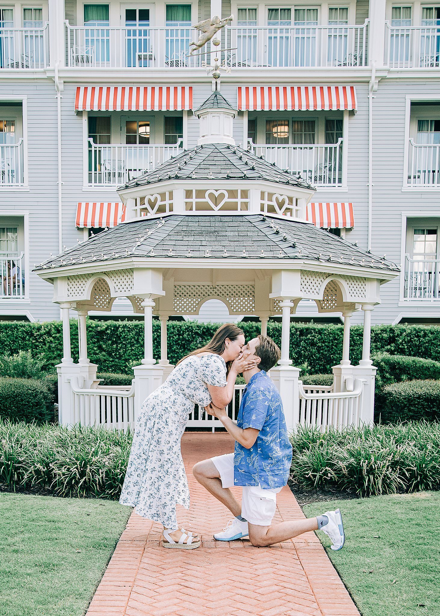 Surprise proposal at Disney's Beach Club Gazsebo, kissing man on one knee