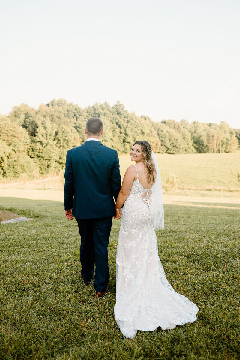 bride and groom holding hands by lexington wedding photographer