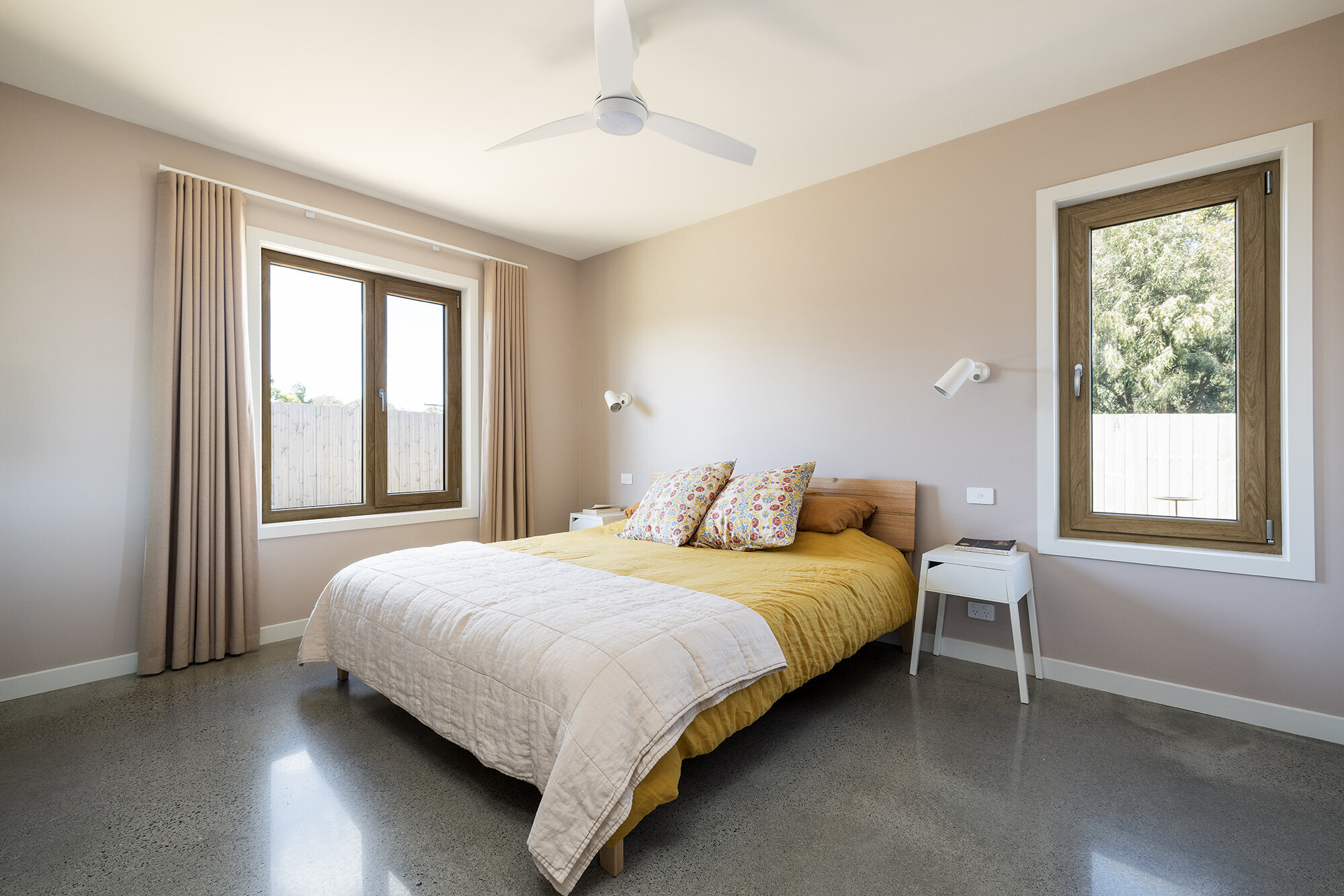 bEDROOM POLISHED CONCRETE CIELING FAN LINEN BEDDING